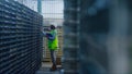 Female storekeeper checking boxes making notes analysing factory distribution