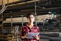 Female storekeeper checks availability of goods with documents in the building materials warehouse