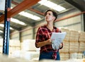 Female storekeeper checks availability of goods with documents in the building materials warehouse