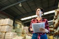 Female storekeeper checks availability of goods with documents in the building materials warehouse