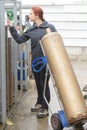 Female storekeeper taking gas bottle