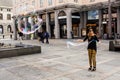 A female street performer creates large bubbles in the main city square of Bergen