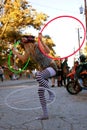 Female Street Performer Entertains With Three Hula Hoops