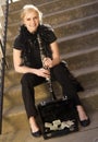 Female Street Performer Sits on Steps Clarinet Case With Tips Royalty Free Stock Photo