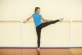 Female stretching in colorful fitness class with handrail Royalty Free Stock Photo