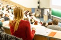 Female student attending faculty lecture workshop making notes. Royalty Free Stock Photo