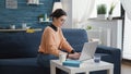 Female student browsing internet on laptop to write report