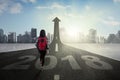 Student walking on the road with upward arrow Royalty Free Stock Photo