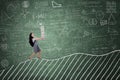 Female student carrying books on blackboard Royalty Free Stock Photo