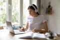 Female student in earphones study using laptop Royalty Free Stock Photo