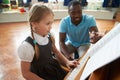 Female Student Enjoying Piano Lesson With Teacher