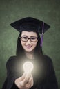 Female student giving bright light bulb Royalty Free Stock Photo