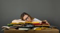 Tired student with glasses sleeping on books in the library Royalty Free Stock Photo