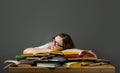 Tired student with glasses sleeping on books in the library Royalty Free Stock Photo