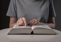 Female student hands close up, pointing on text in book or textbook, searching for information and reading at night Royalty Free Stock Photo