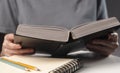 Female student hands close up, pointing on text in book or textbook, searching for information and reading at night Royalty Free Stock Photo