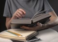 Female student hands close up, pointing on text in book or textbook, searching for information and reading at night Royalty Free Stock Photo