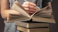 Female student hands holding pencil and reading book, prepare for exam at table at night. Education concept Royalty Free Stock Photo