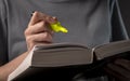 Female student hands holding yellow highlighter and reading book or textbook, making notes, underlines, prepare for exam Royalty Free Stock Photo