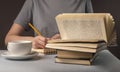 Female student hands underline information in book, prepare for exam, cup of tea or coffee, holding pencil. Education Royalty Free Stock Photo