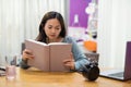 Female Student in house read text book Royalty Free Stock Photo