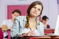 Female student with laptop in classroom