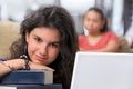 Female student leaning on books' pile Royalty Free Stock Photo