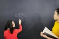 Female student learns math with her teacher Royalty Free Stock Photo