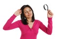 Female student looking through a magnifying glass Royalty Free Stock Photo