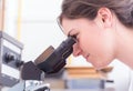 Female student looking into the microscope Royalty Free Stock Photo