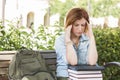 Female Student Outside with Headache Sitting with Books and Back Royalty Free Stock Photo