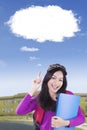 Female student pointing at a cloud bubble Royalty Free Stock Photo