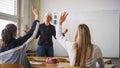 Female student raising hand and answering a teacher question Royalty Free Stock Photo