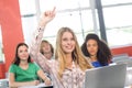 Female student raising hand in classroom