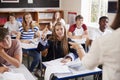 Female Student Raising Hand To Ask Question In Classroom Royalty Free Stock Photo