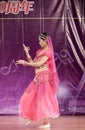 Female student in red perform indian dance