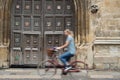 Female Student Riding Old Fashioned Bicycle Around Oxford University College Buildings With Motion Blur Royalty Free Stock Photo