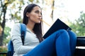 Female student sitting on the bench with book Royalty Free Stock Photo