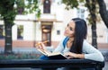 Female student sitting on the bench with book Royalty Free Stock Photo