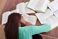 Female student sleeping with books at classroom desk Royalty Free Stock Photo