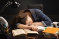 Female student sleeping with books at her desk Royalty Free Stock Photo