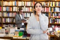 female student standing in bookshop Royalty Free Stock Photo