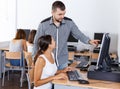 Female student studying in computing class with teacher Royalty Free Stock Photo
