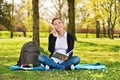 Female student in a park talking on the phone Royalty Free Stock Photo