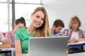 Female student using laptop in classroom Royalty Free Stock Photo