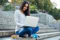 Female student using laptop computer outdoors Royalty Free Stock Photo