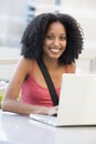 Female student using laptop outside