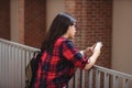 Female student using mobile phone in corridor Royalty Free Stock Photo