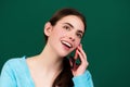 Female student using phone in classroom. School girl chatting on mobile phone near blackboard. College, high school or Royalty Free Stock Photo