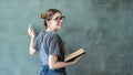 Female student writing on green chalkboard Royalty Free Stock Photo